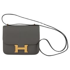 Hermes mini constance cross body 18cm in gris meyer epsom leather and gold tone hardware. Date stamp B for 2023. Shoulder strap drop 20". Comes with felt, original dustcover and box. Mini Constance Hermes, Constance Hermes, Mini Constance, Luxury Bags Collection, Date Stamp, Hermes Constance, Fashion Handbags, Purses Crossbody, Luxury Bags