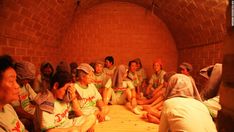 a group of people sitting in a brick tunnel