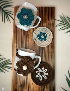 crocheted coffee cup cozyies on a wooden table