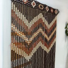 the beaded wall hanging is decorated with beads