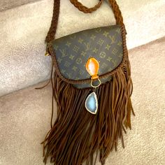 Vintage Boho Lv World Traveler Bag. Never Worn. Comes With Two Stones To Switch Out. Louis Vuitton Crossbody Bag Western, Upcycled Louis Vuitton Purse, Western Boho Handbags, Boho Louis Vuitton Bag, Upcycled Louis Vuitton Bag, Louis Vuitton Fringe Purse, Vintage Boho Handbags, Fringe Louis Vuitton Backpack, Louis Vuitton Fringe Crossbody Bag