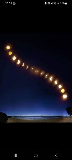 an image of a long line of moon phases in the night sky with lights on