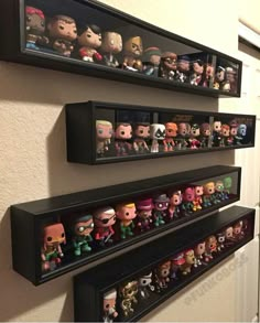 three black shelves filled with different types of pop culture figurines on the wall