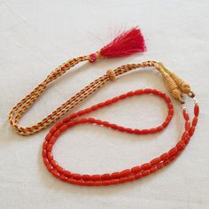 The product is made according to the model of authentic Indian jewelry. They make necklace even more refined and original. The coral is natural The ties are made of silk fabrics. They are pleasing to the body and make your look interesting even from behind. First come, first served! Type of metal: Coral Beads With (silk fabrics) Full length: 50.8cm/20inches ※including no clasp Necklace Weight: 16 Gm Beads size: Length - 9-4mm. Depth - 4-3.5mm. ※Size is approx. Type of coral: Natural Italian cora Traditional Coral Necklace With Gemstone Beads, Traditional Orange Beads For Gifts, Adjustable Hand-strung Red Coral Necklace, Traditional Adjustable Beaded Necklaces With Gemstone Beads, Adjustable Traditional Beaded Necklaces With Gemstone Beads, Traditional Adjustable Single Strand Beaded Necklaces, Traditional Red Beaded Necklace For Meditation, Traditional Adjustable Single Strand Beaded Necklace, Traditional Coral Single Strand Necklace