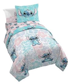 the stitcher bedding set is made up of blue and pink flowers with stitchers on