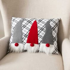 a pillow with three gnome hats on it