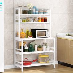 a microwave is sitting on top of a shelf in a kitchen with other items and utensils