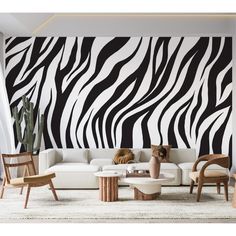 a living room with zebra print on the wall and white couches in front of it