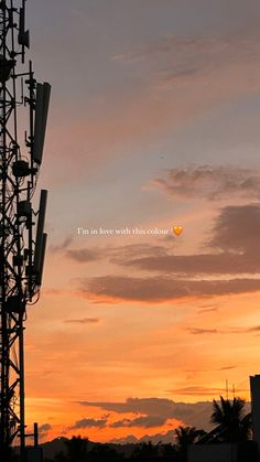 the sun is setting behind a cell tower