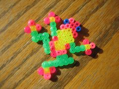 small plastic beads sitting on top of a wooden table