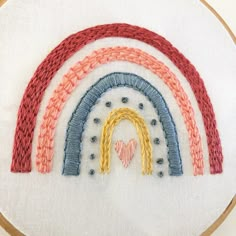 an embroidered rainbow is shown in the hoop