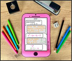 a pink tablet sitting on top of a wooden table next to pencils and markers