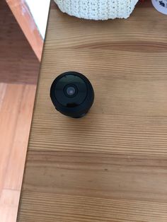 a camera sitting on top of a wooden table