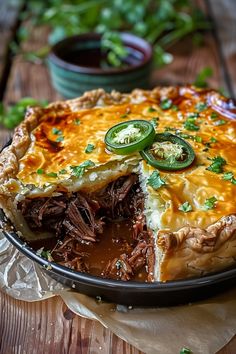 a meat and cheese pie on a wooden table