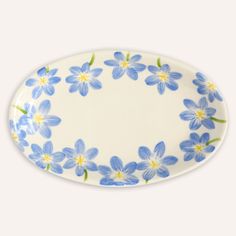 a blue and white plate with flowers on it