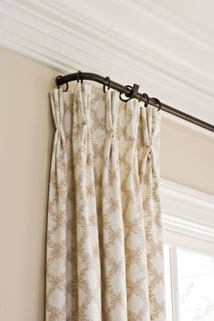 the curtain is hanging on the rod in front of the window with curtains pulled back