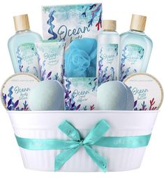 a white bucket filled with soaps and hand lotion next to a blue ribbon