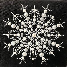 a black and white painting with some dots on it's surface, in the shape of a snowflake