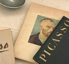 two books sitting on top of a table next to a cup and saucer in front of them