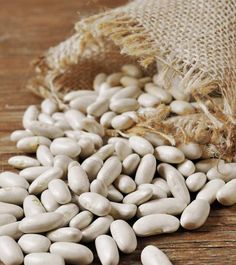 white beans spilling out of a burlap bag