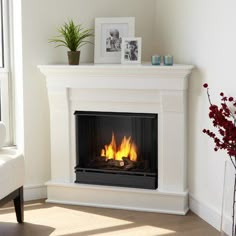 a living room with a couch and a fire place in the corner, next to a window