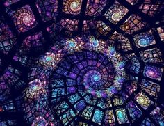 the inside of a stained glass window with many circular designs on it's sides