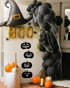 balloons and decorations are arranged on the wall in this halloween themed home decorating idea