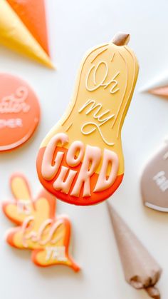 an orange and yellow cookie with the word gord on it next to other cookies