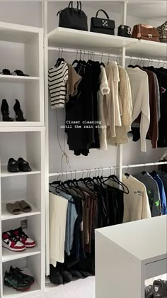 a white closet filled with lots of clothes and handbags on top of shelving units