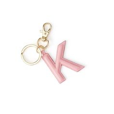 a pink keychain with the letter k on it's front and back ends