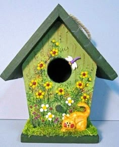 a birdhouse with a cat and dog in it