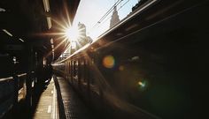 the sun is shining down on a train