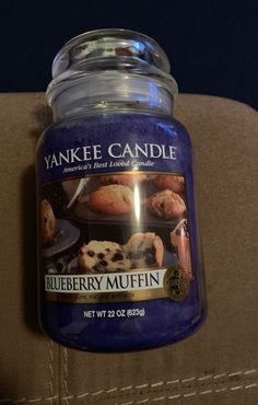 a blueberry muffin candle sitting on top of a couch