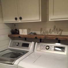 a washer and dryer sitting in a kitchen next to each other on top of cabinets