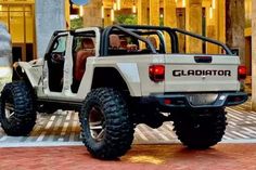 a white jeep parked in front of a building