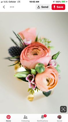 an arrangement of flowers on a white surface