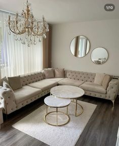 a living room filled with furniture and a chandelier