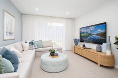 a living room filled with furniture and a large flat screen tv mounted on the wall