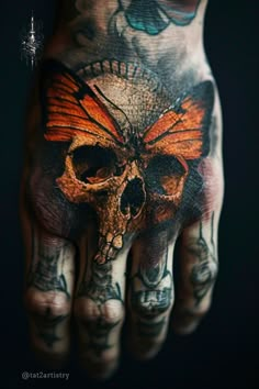 a hand with a skull and butterfly on it