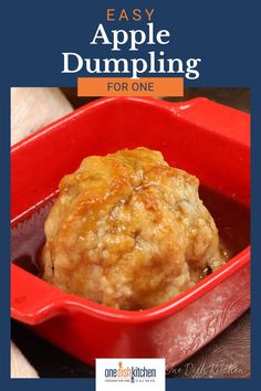 an orange casserole dish with the words easy apple dumpling for one