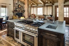 a kitchen with an oven, stove and dining room table