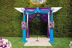 an outdoor wedding ceremony setup with purple and blue decor