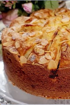 a close up of a cake on a plate with flowers in the backgroud