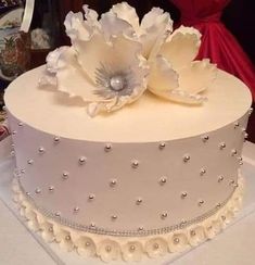 a large white cake with flowers on top