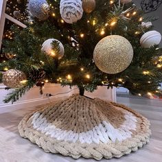 a crocheted christmas tree skirt under a decorated christmas tree