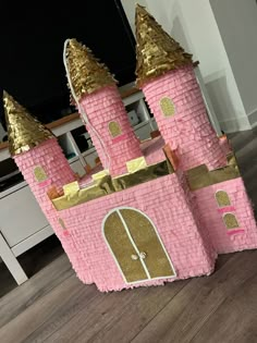 a pink and gold castle made out of cardboard