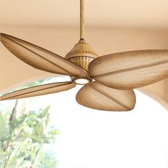 a ceiling fan with wooden blades hanging from the ceiling