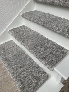 three gray rugs sitting on the floor next to each other