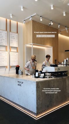 two people standing behind a counter in a restaurant