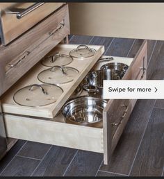 an open drawer with pots and pans in it